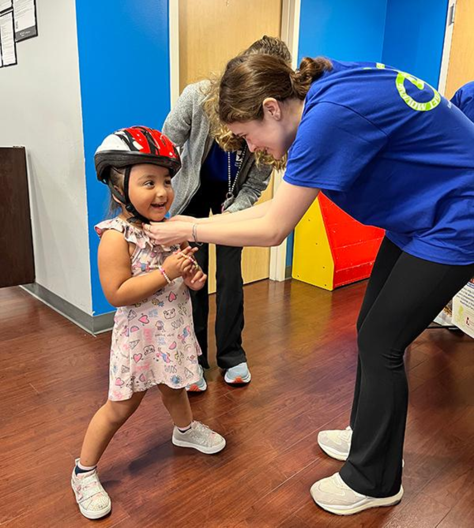 At the event, kids learned how to properly fit a helmet on their heads and how to safely ride bikes. (Photo by Simone Sonnier/UT Physicians) 在活动中,孩子们学习了如何正确佩戴头盔,以及如何安全骑自行车。(图片来源:Simone Sonnier/UT Physicians)